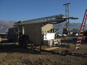 Aluminum mobile communication unit on wheels with an Aluma tower rested on top