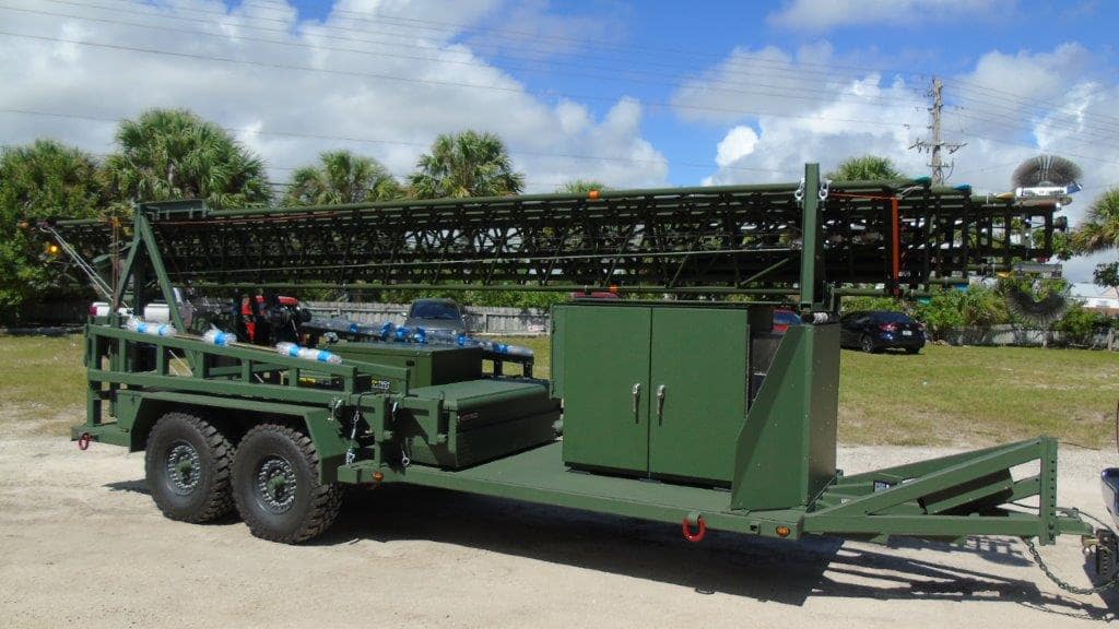 Aluma green military trailer system on wheels with unguyed telescoping tower on top