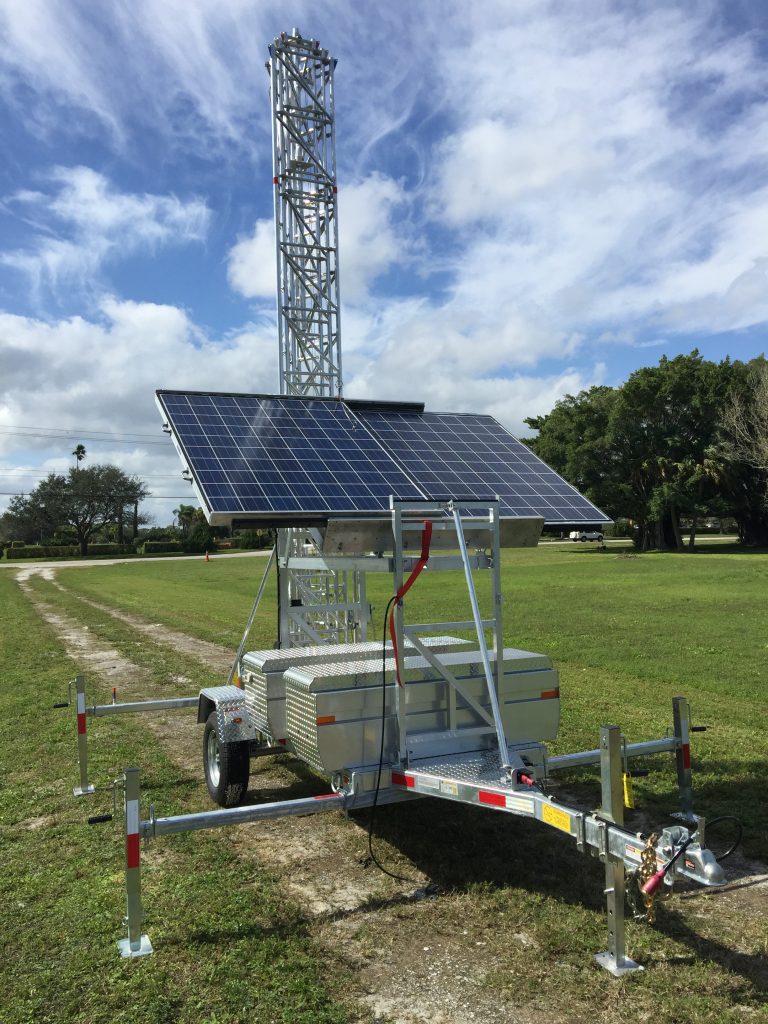 Custom mobile tower with solar panels in a field
